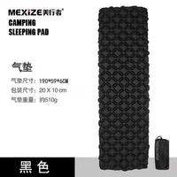 Lightweight inflatable tent sleeping mat set up outdoors on grass with blue camping backpack